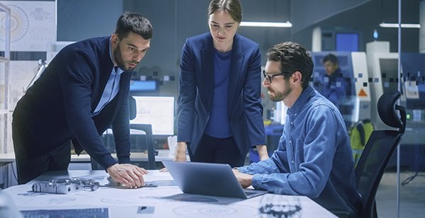 engineers at desk with laptop
